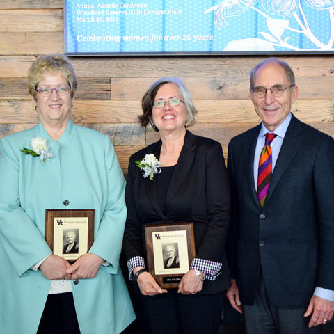 photos of 2018 Sarah Bennett Holmes Award winners Debra Moser and Lisa Collins with President Eli Capilouto.