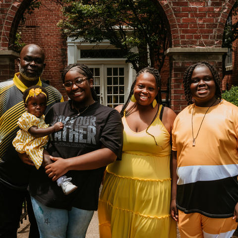 Image of family of four standing outside