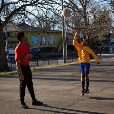 Bryan Greene, 25, and Lakell Gates, 11, play basketball on the court in Duncan Park in Lexington, Kentucky, on Sunday, Feb. 2, 2020.