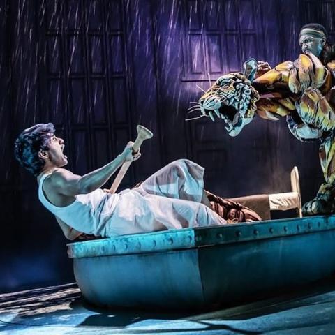 Actor in a lifeboat being threatened by a Bengal tiger puppet