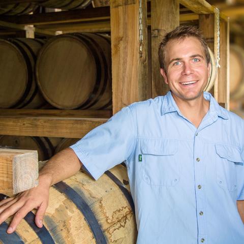 photo of Seth Debolt among bourbon barrels