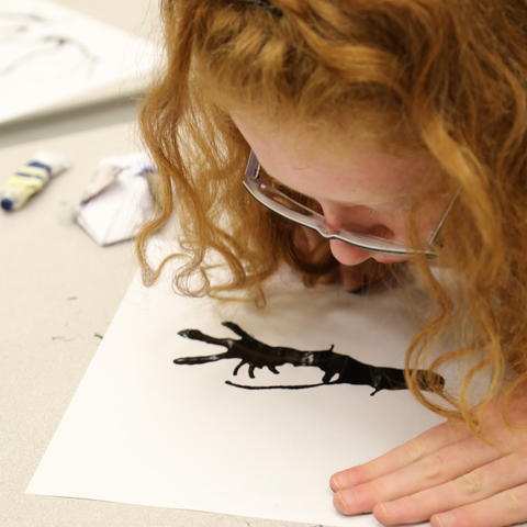 photo of student working on art at  2 kids eating at UK Confucius Institute Spring Break Camp