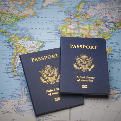 photo of 2 passports on world map