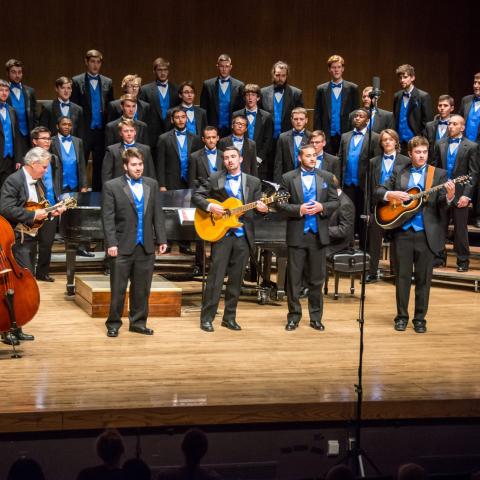 UK Men's Chorus on stage with group of instrumentalists