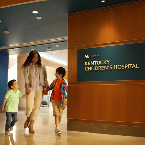 Photo of mother and young children walking out Kentucky Children's Hospital