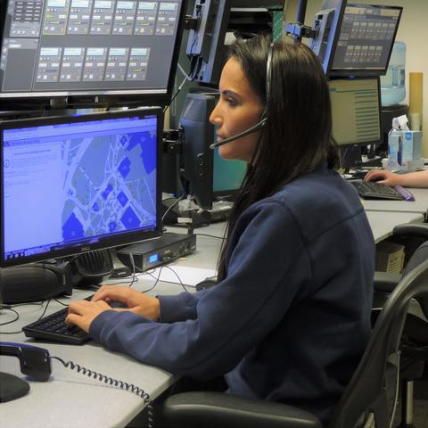 photo of UK dispatchers Heather Terrell, left, and Kortnie Osbourne, right, at their workstations at UKPD.
