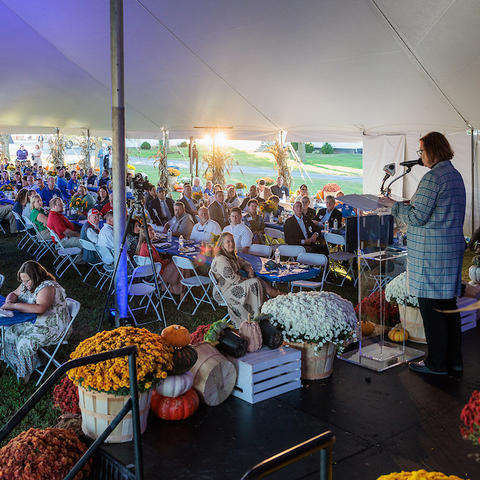 a crowd of people are seated underneath a tent at UK's Research and Education Center in Princeton, Kentucky