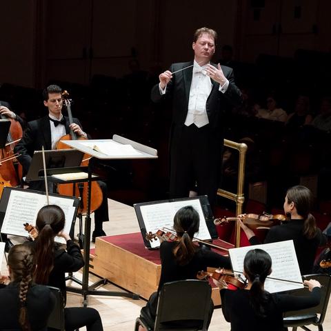 photo of John Nardolillo conducting members of UK Symphony Orchestra at Carnegie Hall