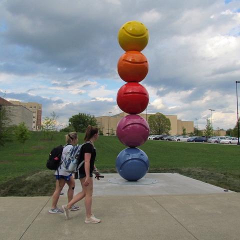 photo of 2 students passing by "Mood Sculpture" by Tony Tasset