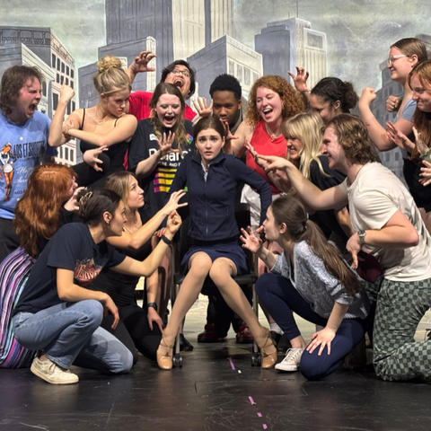 Actors on stage during a musical theater rehearsal