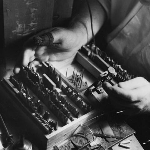 black and white photo of Victor Hammer's hands working on a press