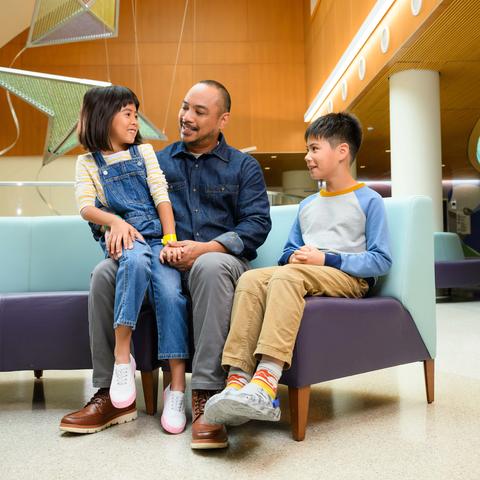 Image of family sitting in the lobby of Kentucky Children's Hospital