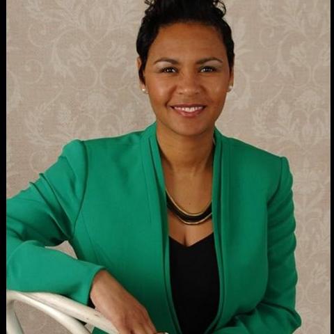 Catrena Bowman-Thomas pictured wearing green blazer against taupe background