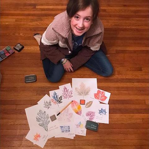 Brenna Mefford shows off her leaf print collection that she made in another 4-H program. 4-H'ers who become Junior Master Naturalists will make a similar collection