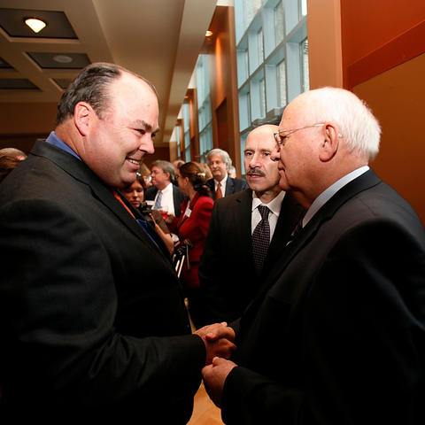 Ambassador Cavanaugh (left) shaking hands with former USSR President Mikhail Gorbachev (right)