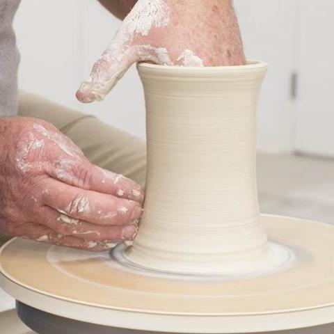 photo of hands work on ceramic vase - Fine Arts Institute