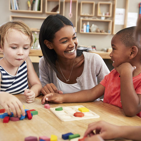 photo of teacher talking to children in child care setting