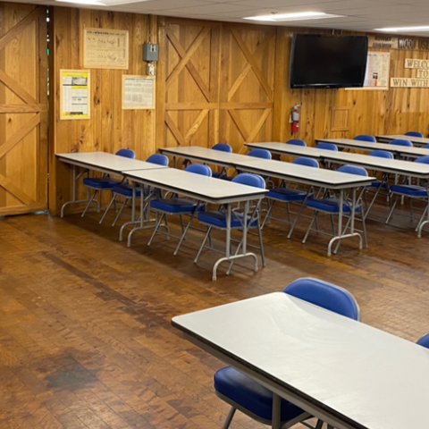 Image of classroom with tables and blue chairs
