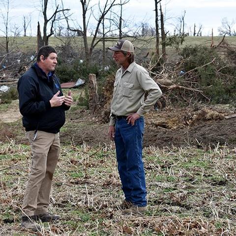 Darrell Simpson, left, Muhlenberg County agriculture and natural resources extension agent, talks with livestock producer Kenny Smith