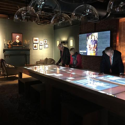 photo of people using interactive table in Gracious room of Kentucky Bourbon Trail Welcome Center