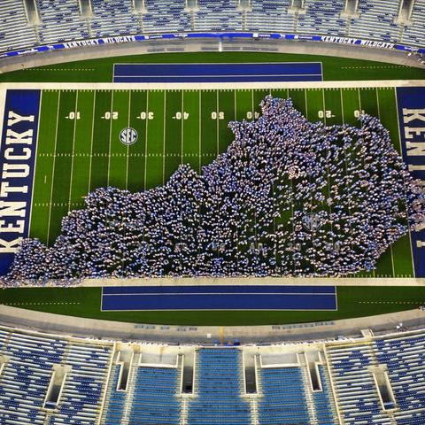 students making the shape of Kentucky on the football field