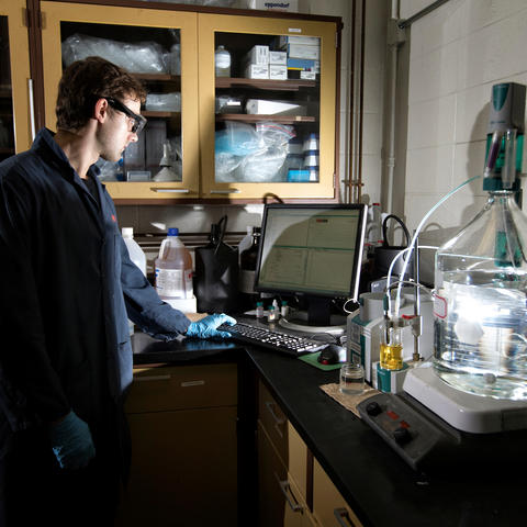 photo of young man in a lab