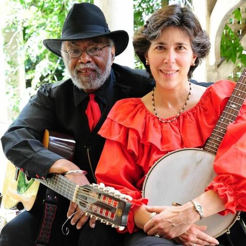 photo of Sparky and Rhonda Rucker seated holding guitar and banjo