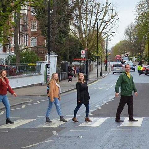 UK students from left: Catie Archambeau, Arizzona Albright and Emma Rosenzweig and Jason Swanson, UK associate professor, recreate the famous Beatles album cover at the Zebra Crossing at Abbey Road Studios in London